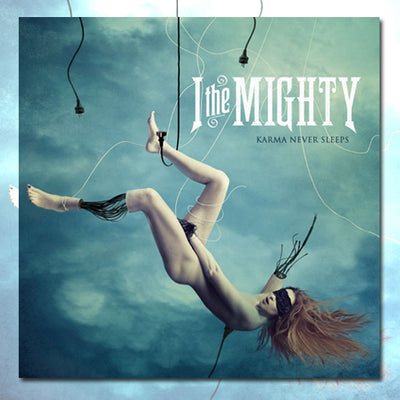 A blindfolded robotic woman falling through a stormy sky, being caught mid air by electrical plugs. The words "I the Mighty" are in the top right of the frame, with "Karma Never Sleeps" slightly below it.