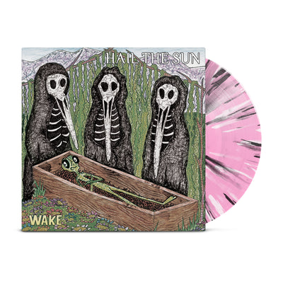 Album art of three skeletal figures standing around a casket containing a smirking green alien. Baby pink colored vinyl record with black and white splatter poking out of the sleeve.