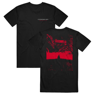 Black t-shirt with "CODESEVEN" printed in white in upper right corner. Below this "GO LET IT IN" is printed in red. Back of shirt has picture of person's silhouette and swirls and shapes are above and below them. The picture is in black and red and covers most of the back of the shirt.