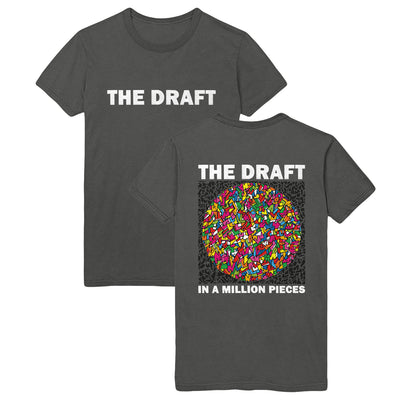 Charcoal gray t-shirt with words "THE DRAFT" printed in bold white towards top center of shirt. Back of shirt has "THE DRAFT" printed in same bold, white color towards the top. Below is a drawing of a circle with several small shapes in different colors (yellow, pink, orange, blue, green). Below the drawing reads "IN A MILLION PIECES" in the same bold white font. 