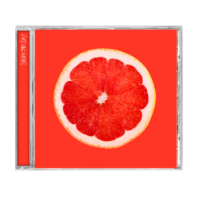 Bright orange colored CD with an image of the inside of a grapefruit in the center. Along the spine there is text that says SAVES THE DAY.