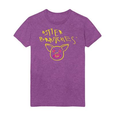 Purple tshirt with scratchy style yellow text reading Bitter Branches on the top part of the shirt with a yellow outline of a pig face below. Pink Xs are drawn over the pig's eyes and pink lips are drawn over the pig's snout.