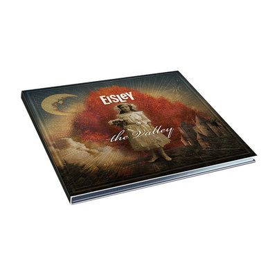 Square CD with artwork of a girl holding flowers standing in front of a red cloud. In the background there is a castle and more clouds. Above her there is white text that says EISLEY. In front of her there is text hat says THE VALLEY.