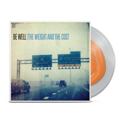 Clear vinyl with thick orange ring towards the center. Vinyl jacket has picture of highway with cars. "BE WELL" is printed in black and "THE WEIGHT AND THE COST" is printed in blue towards top of the jacket.