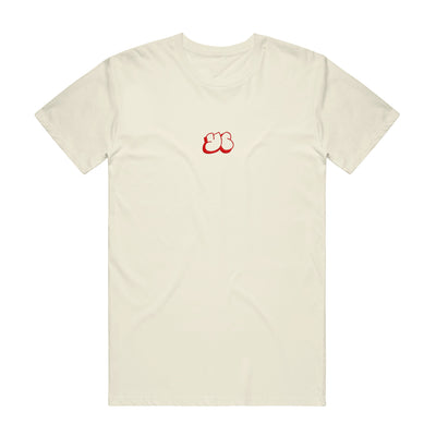 Cream colored t shirt with YC written in the middle of the shirt in small red letters.