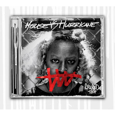 Picture of a CD Case. The cover is a photo of a woman's face, standing in front of a metal fence. The words "House VS Hurricane" Are written in white marker along the top. Covering the woman's mouth its squiggle with a horizontal line going through it. The bottom right corner says "Crooked Teeth" Drawn in marker. 