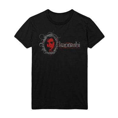 A black Shirt with the word Kaonashi in Grey lettering. Next to it is a mirror with a girls's reflection in blood red colors. She is crying.