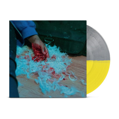 Vinyl jacket with an image of a person laying on the ground with their hand covered in blood. Surrounding their hand are white feathers, some covered in blood. All of this is on light wooden flooring. Peeking out of the right hand side of the vinyl is a grey and yellow vinyl.