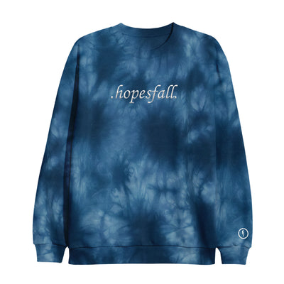 Tie-dye navy blue crewneck with "hopesfall" embroidered in center of crewneck in white. Picture of a floating silhouette with a circle around it in white is printed on the bottom right sleeve.