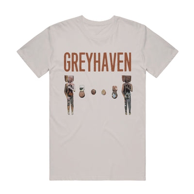 Sand colored short sleeve t-shirt with abstract graphics of characters with boxes and strange colors on them.  Above the characters is text that reads GREYHAVEN.