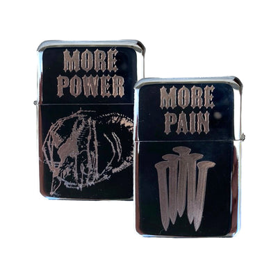 Flip lighter with the words more power and an animal skull wrapped in barbed wire on one side. Text that reads more pain with a bunch of railroad spikes show on the other side.