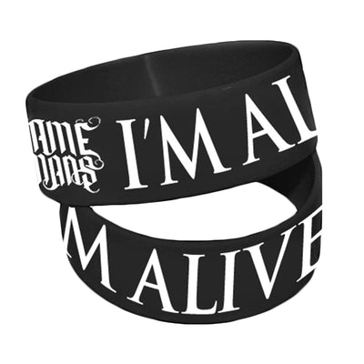 2 black wrist bands against white background. Wrist bands have "WE CAME AS ROMANS" and "IM ALIVE" printed on them in white.