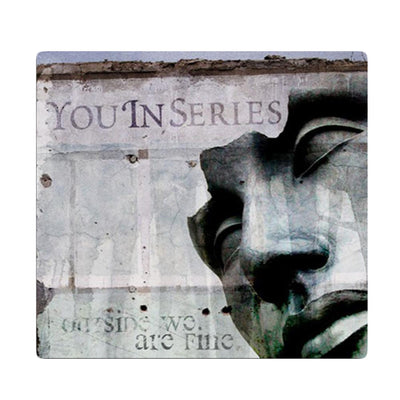 CD against white background. CD cover is a picture of a gray wall and a person's face made of stone on the right side. The upper left side has "YOU IN SERIES" printed and the bottom right has "OUTSIDE WE ARE FINE" printed.