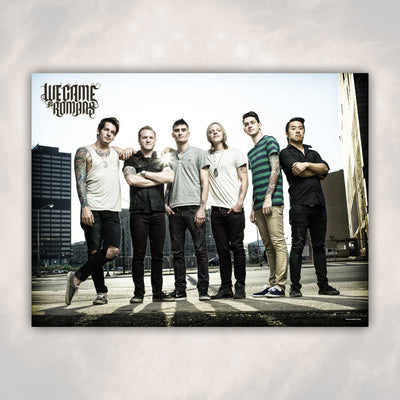 Poster against off white background. Poster has the band members standing in a line with a city in the background. "WE CAME AS ROMANS" is printed in the upper left corner in black.