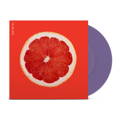 Bright orange colored vinyl jacket with an image of the inside of a grapefruit. In the top left corner there is vertical white text that says SAVES THE DAY. Peeking out of the jacket is a purple vinyl.