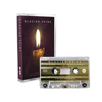 Cassette case with cassette on right hand side. Cassette case is a close up photo of a candle stick with a single flame. The top of the case says GLACIER VEINS in white lettering. On the side of the case, it says GLACIER VEINS in the same design. Cassette to the right of the case is gold striped with GLACIER VEINS written on top in white.