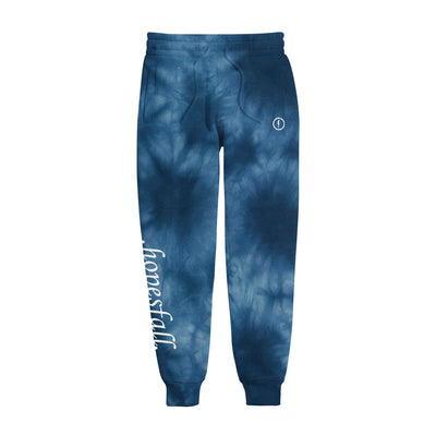 Tie-dye navy blue joggers with picture of a floating blue silhouette with a circle around it in same blue color printed on top right. "hopesfall" is printed on bottom left leg of jogger in white.