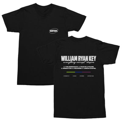 Black short sleeve shirt with WRK written in the top corner surrounded by an oval. On the back of the shirt, there is large white text that says WILLIAM RYAN KEY. Underneath that, there is cursive lettering that says EVERYTHING EXCEPT DESIRE. Below that is a numbered track list. Below that, there is a color blocked line, of green, dark blue, and purple.