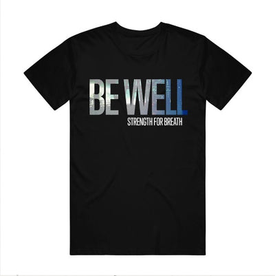 Black t shirt against white background. Center of shirt has "BE WELL" printed with a picture printed inside the letters. Below has "STRENGTH FOR BREATH" printed on right side.