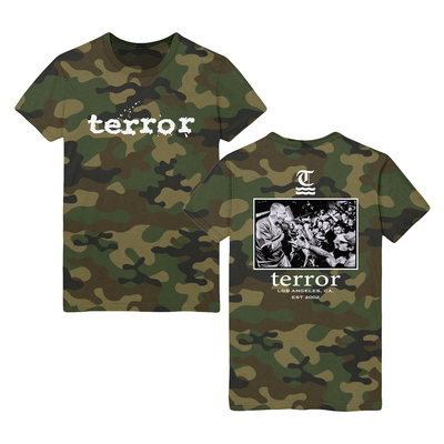 Green camouflaged shirt with white text that says terror across the chest. The back of the shirt says terror in white text below a live shot in black and white. Above the image there is a letter T underlined with two wavy lines. 